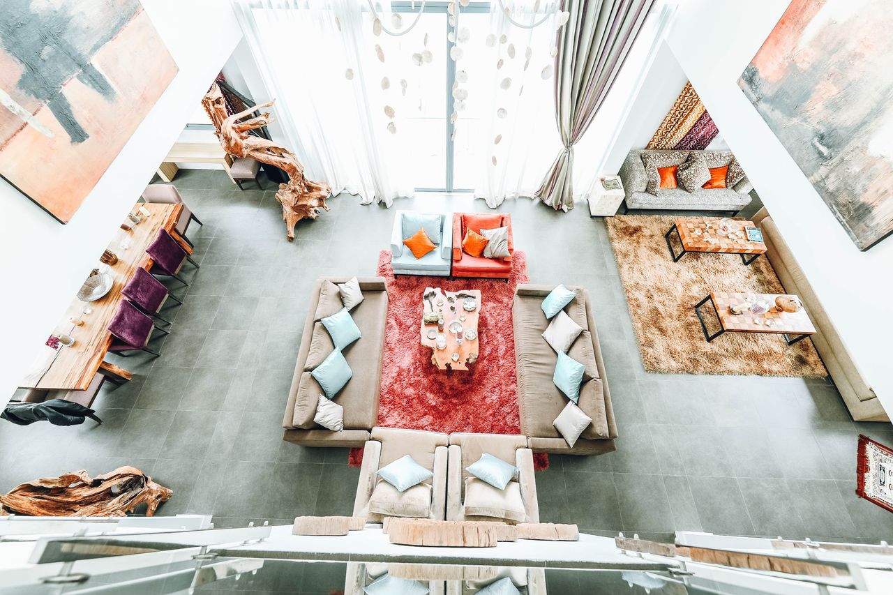 Bright, spacious living room with contemporary design, featuring cozy sofas and vibrant decor elements.